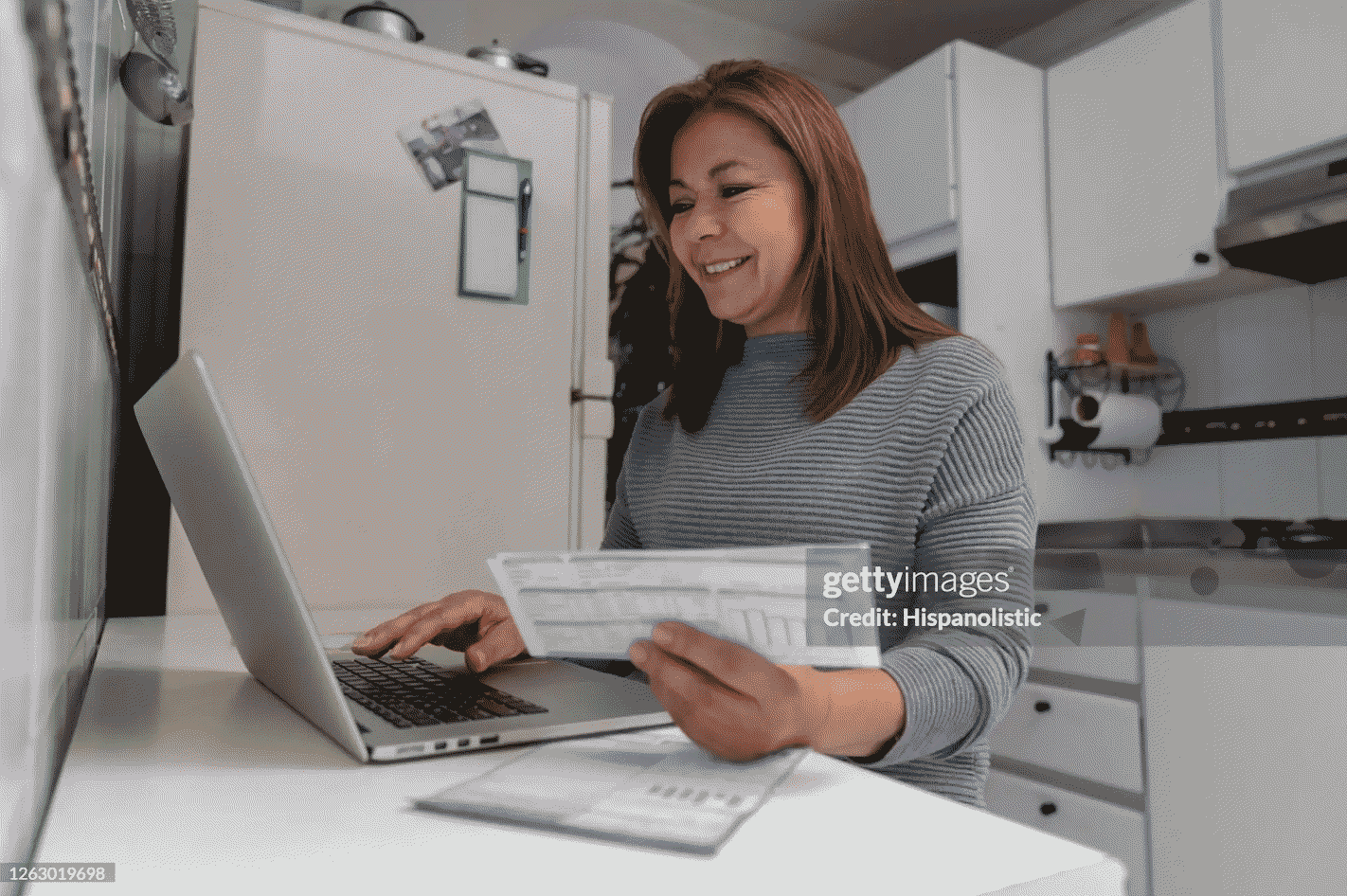 Satisfied renter reading her credit score on her laptop